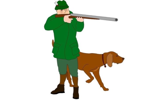 κυνηγός με όπλο και σκύλο